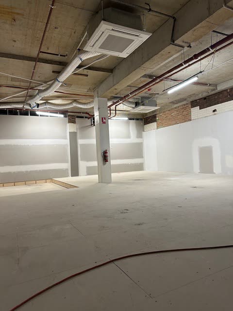 Retail or office shell with a ceiling cassette installed, fire services and concrete soffit above.