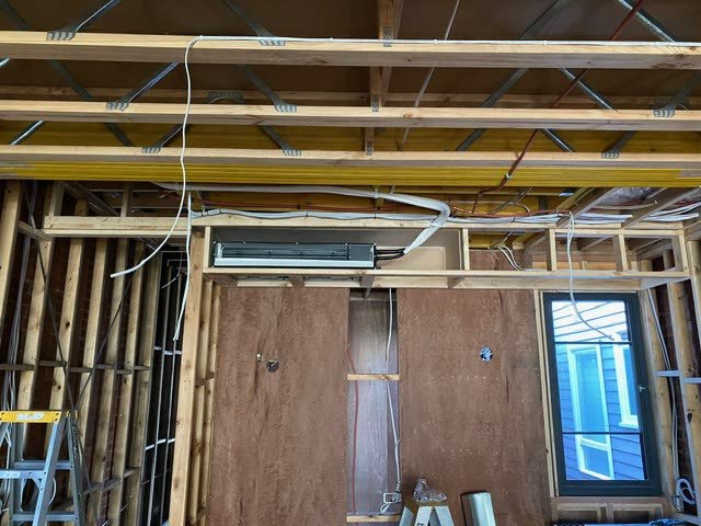Ducted system fan coil and ductwork installed in a new build still in timber frame.