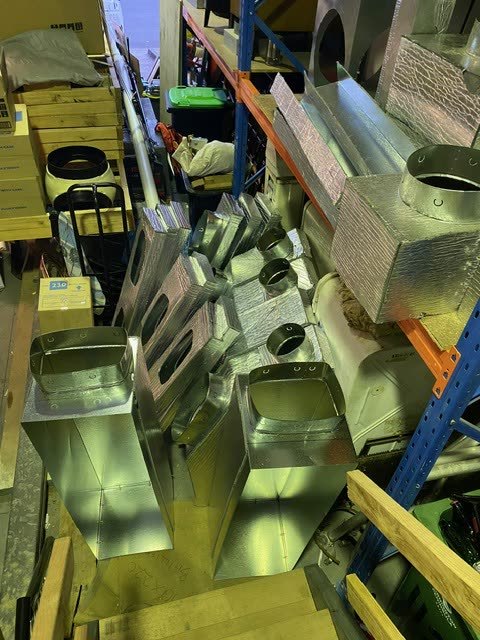Sheet metal plenums and ductwork sections being fabricated in the workshop.